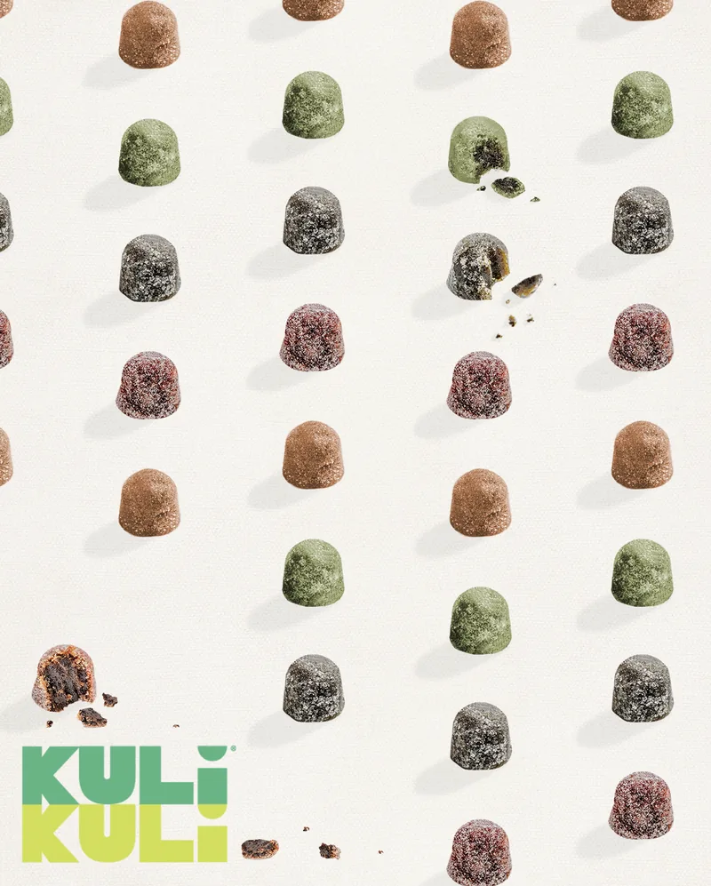 Rows of Kuli Kuli gummies in green, berry and cocoa on white, the logo set into the pattern.
