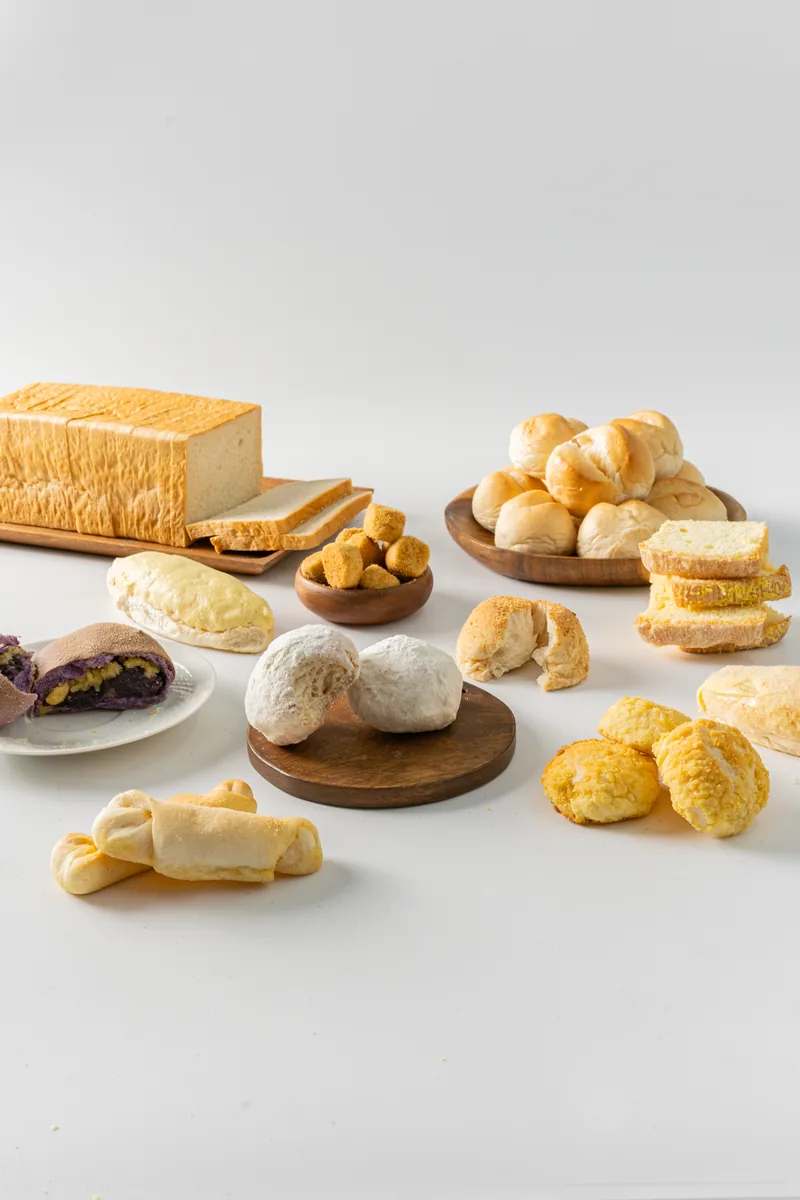 Breads and pastries from the LA Bakeshop range set out across a white surface.