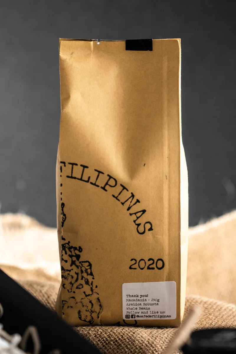 A kraft coffee bag stamped Pilipinas 2020 in warm side light.
